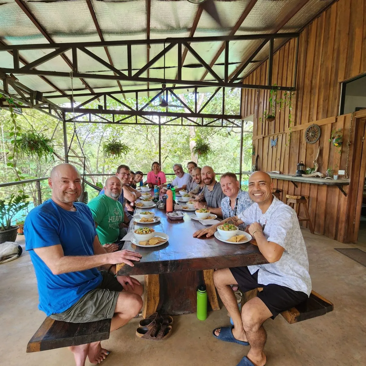 Guests sharing a meal at the long wooden table